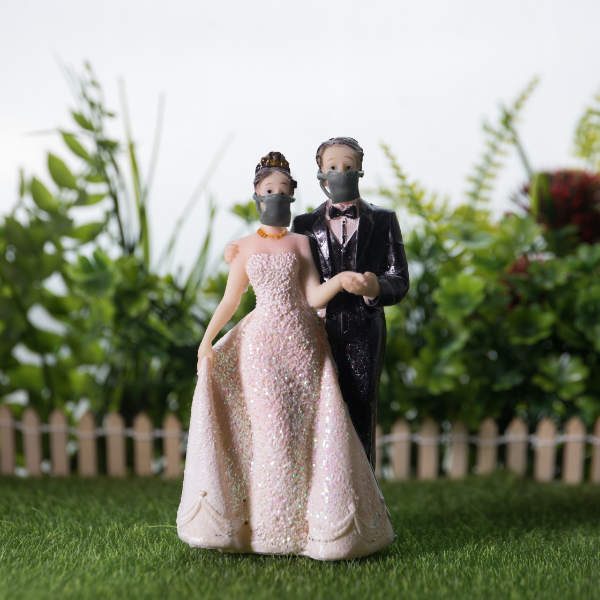 Wedding couple wearing facemasks to shield from the coronavirus