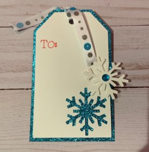 blue and white glitter gift tag with snowflakes