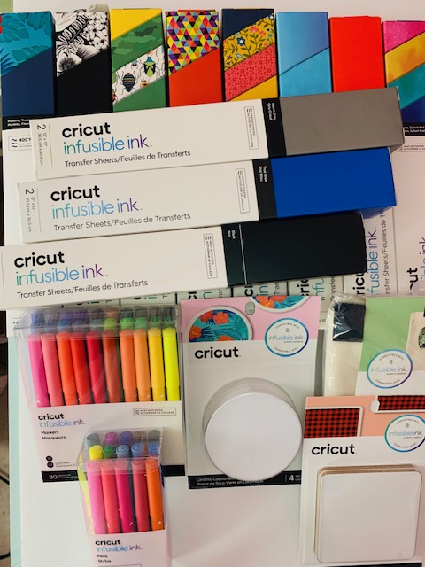 Grouping of Cricut Infusible Ink transfer sheet boxes and blank surfaces