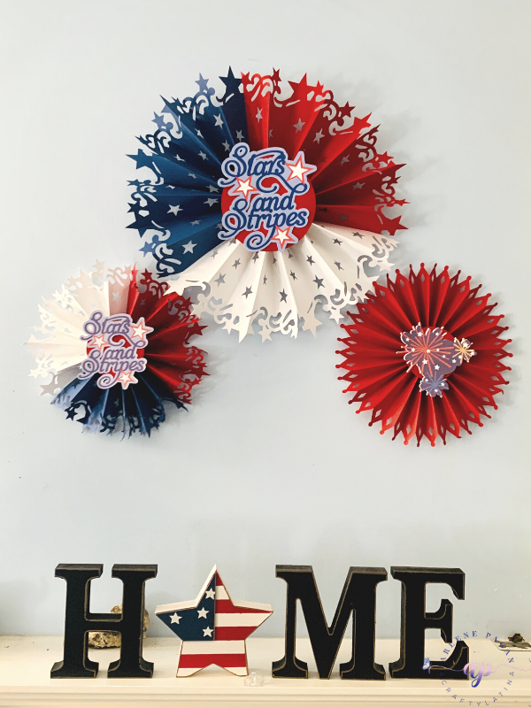 July 4th paper rosettes in red, white and blue.